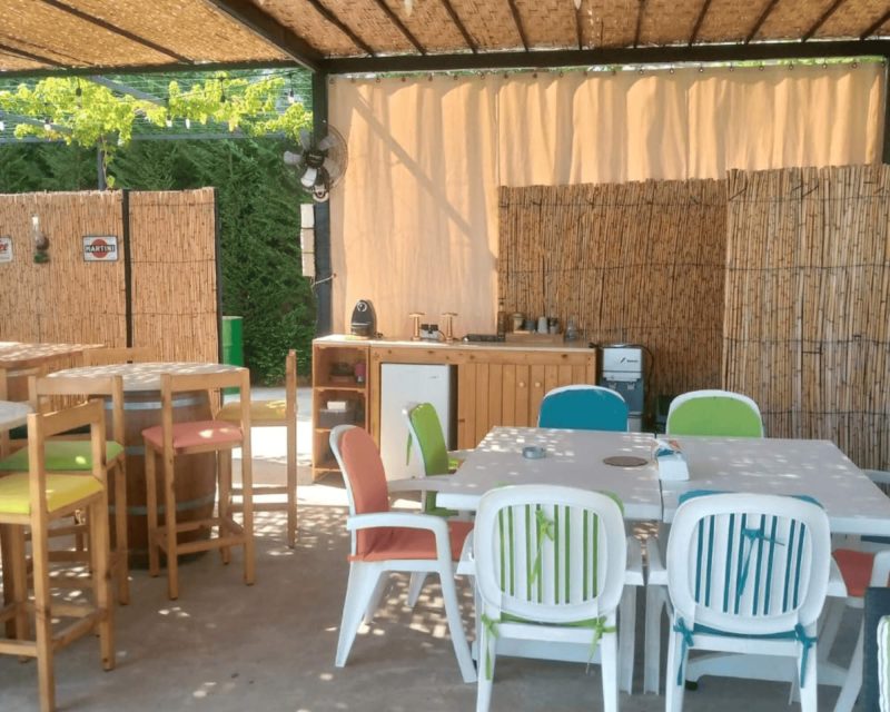 outdoor pergola with salon, dining table and bar